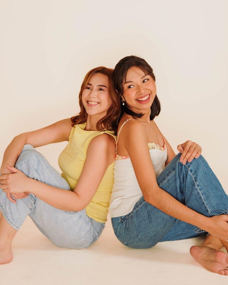 Two Kindred patients sitting back to back, laughing